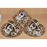 THREE ROYAL CROWN DERBY IMARI 1128 TEACUPS AND SAUCERS, having red printed backstamps, most pieces