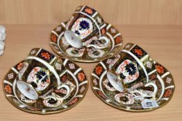 THREE ROYAL CROWN DERBY IMARI 1128 TEACUPS AND SAUCERS, having red printed backstamps, most pieces