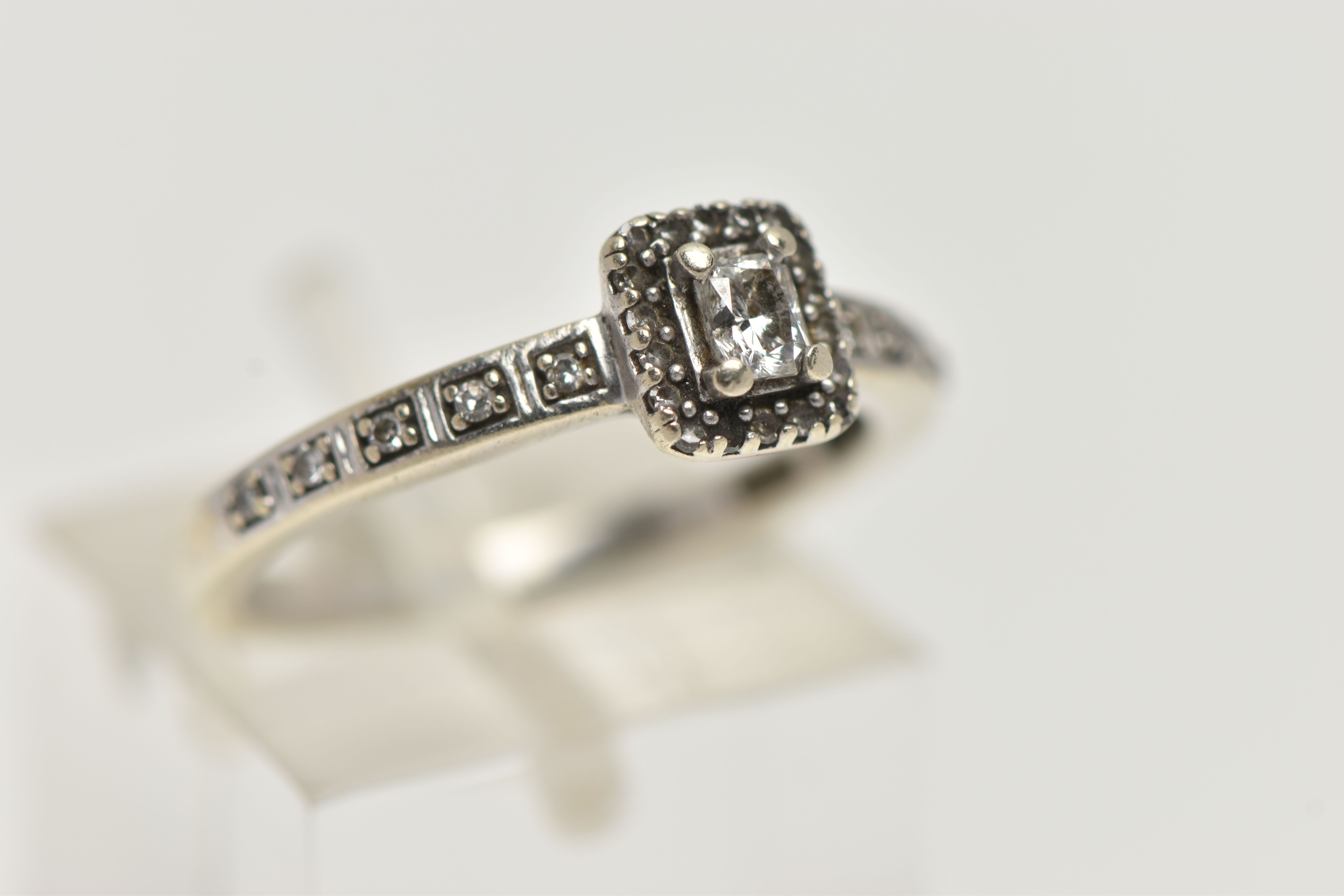 A 9CT WHITE GOLD DIAMOND CLUSTER RING, square head set with an emerald cut diamond, in a surround of - Image 4 of 4