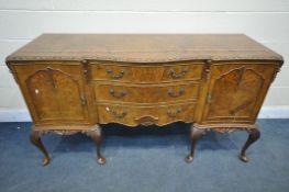 A REPRODUCTION QUEEN ANNE STYLE WALNUT SERPENTINE SIDEBOARD, with double cupboard doors, that's