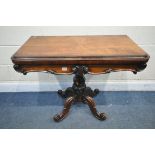 A VICTORIAN ROSEWOOD CARD TABLE, the fold over top enclosing a circular green baize playing surface,