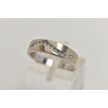 A 9CT WHITE GOLD DIAMOND RING, polished band set with a wavy row of round brilliant cut diamonds,