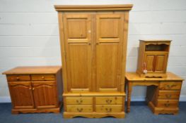 A PINE BEDROOM SUITE, comprising a double door wardrobe with four drawers, width 116cm x depth