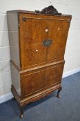 A REPRODUCTION QUEEN ANNE STYLE WALNUT FOUR DOOR DRINKS CABINET, the double door top enclosing a