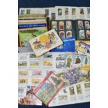 A BOX CONTAINING TWENTY SEVEN TRADE CARD ALBUMS, MOSTLY BROOKE BOND AND A CIGARETTE CARD ALBUM,