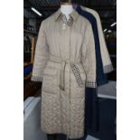 LADIES' AQUASCUTUM SHOWERPROOF COATS, to include two quilted showerproof full length coats, one navy