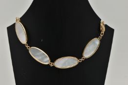 A 9CT GOLD MOTHER OF PEARL BRACELET, designed as a series of seven oval mother of pearl panels, each