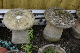 A PAIR MODERN COMPOSITE STADDLE STONES, one with tapered square base, the other circular base,