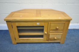 A LIGHT OAK CORNER TV STAND, with a single glazed door and two drawers, width 95cm x depth 50cm x