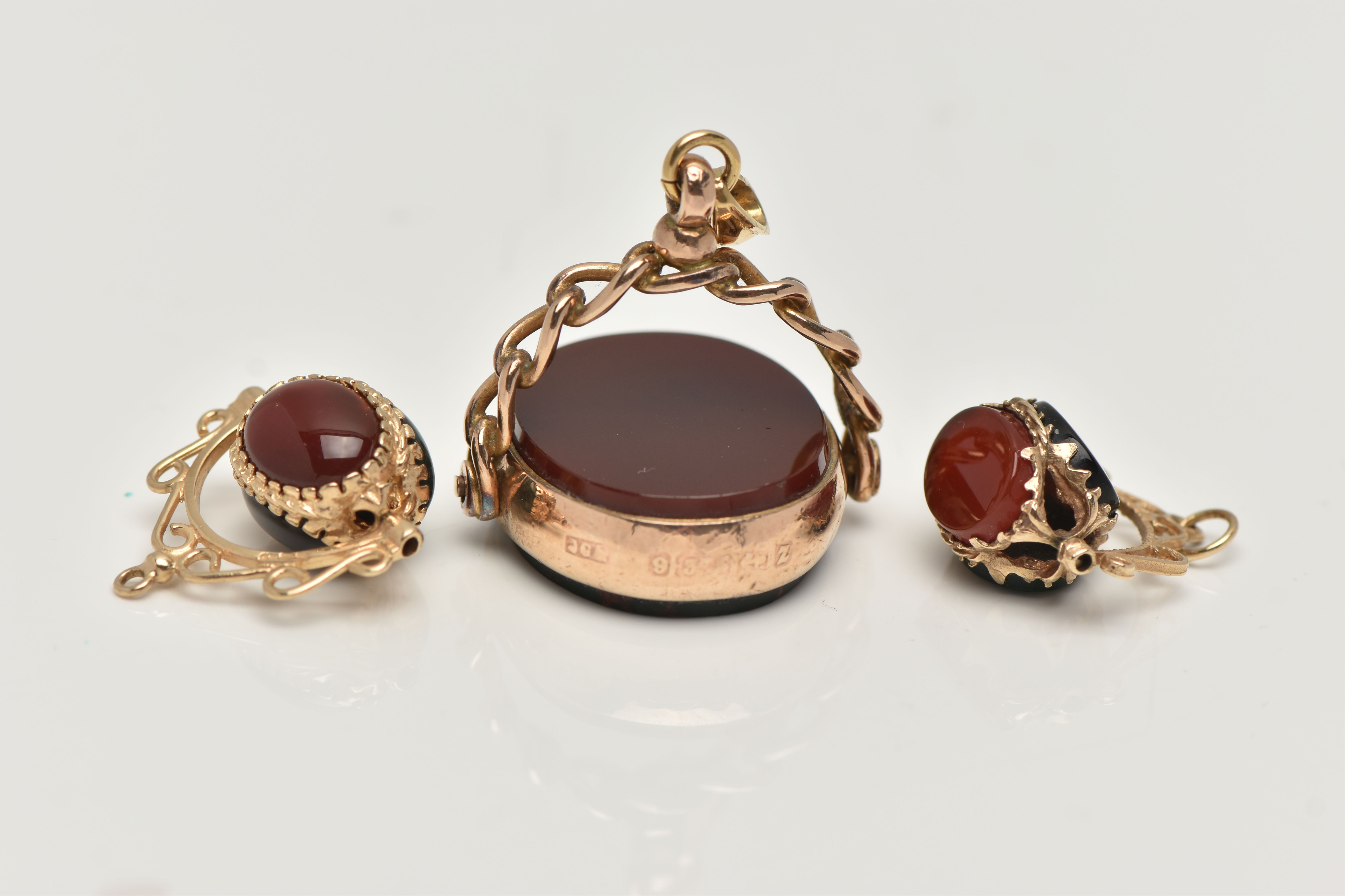 THREE SWIVEL PENDANTS, the first an oval swivel pendant set with a carnelian and a bloodstone inlay, - Image 4 of 4