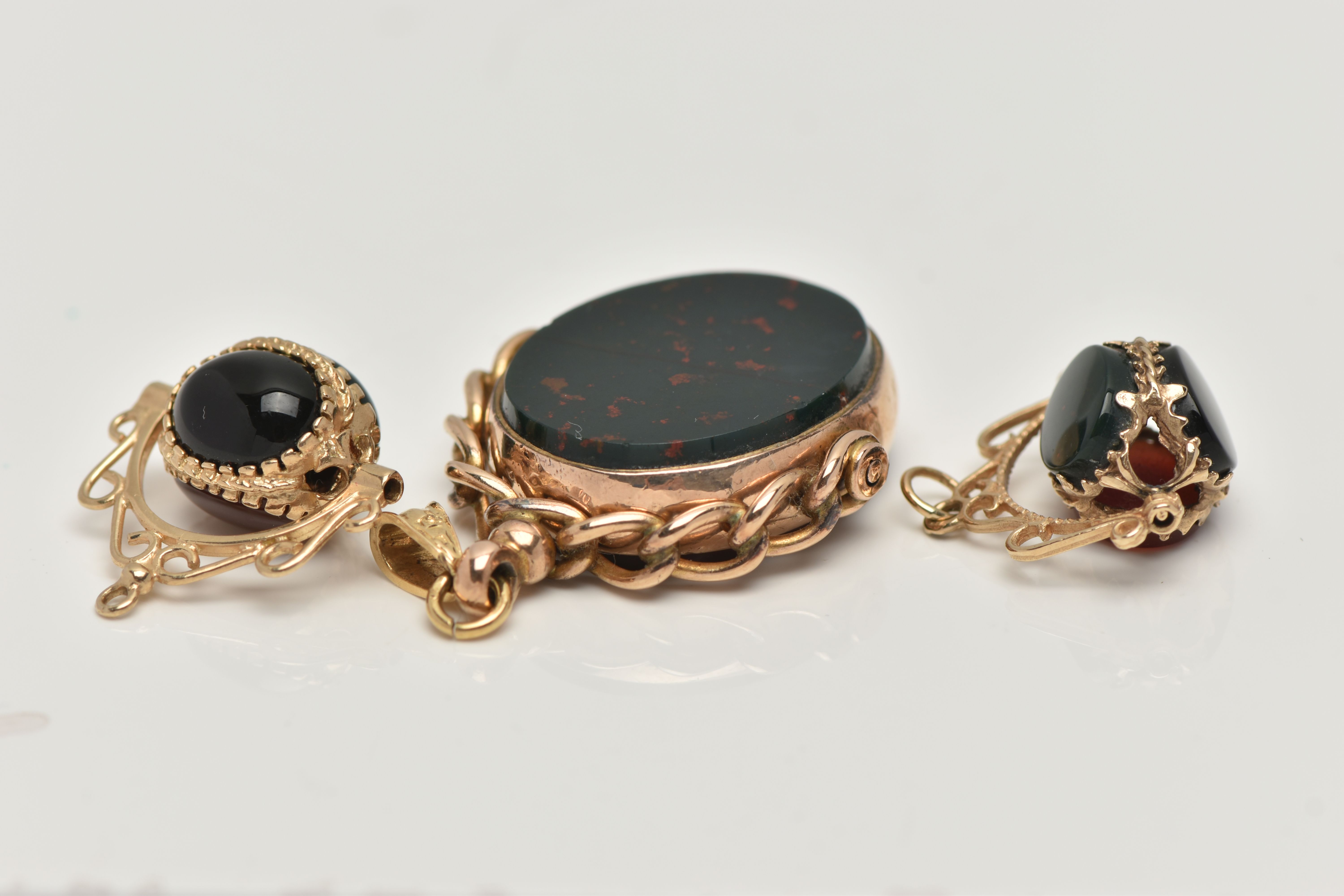THREE SWIVEL PENDANTS, the first an oval swivel pendant set with a carnelian and a bloodstone inlay, - Image 3 of 4