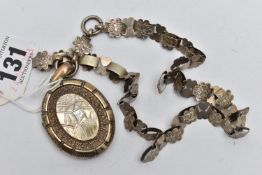 A WHITE METAL LOCKET AND CHAIN, oval engraved locket opens to reveal two photos inside, unmarked,