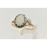A 9CT GOLD OPAL AND DIAMOND CLUSTER RING, centring on an oval opal cabochon, claw set in a