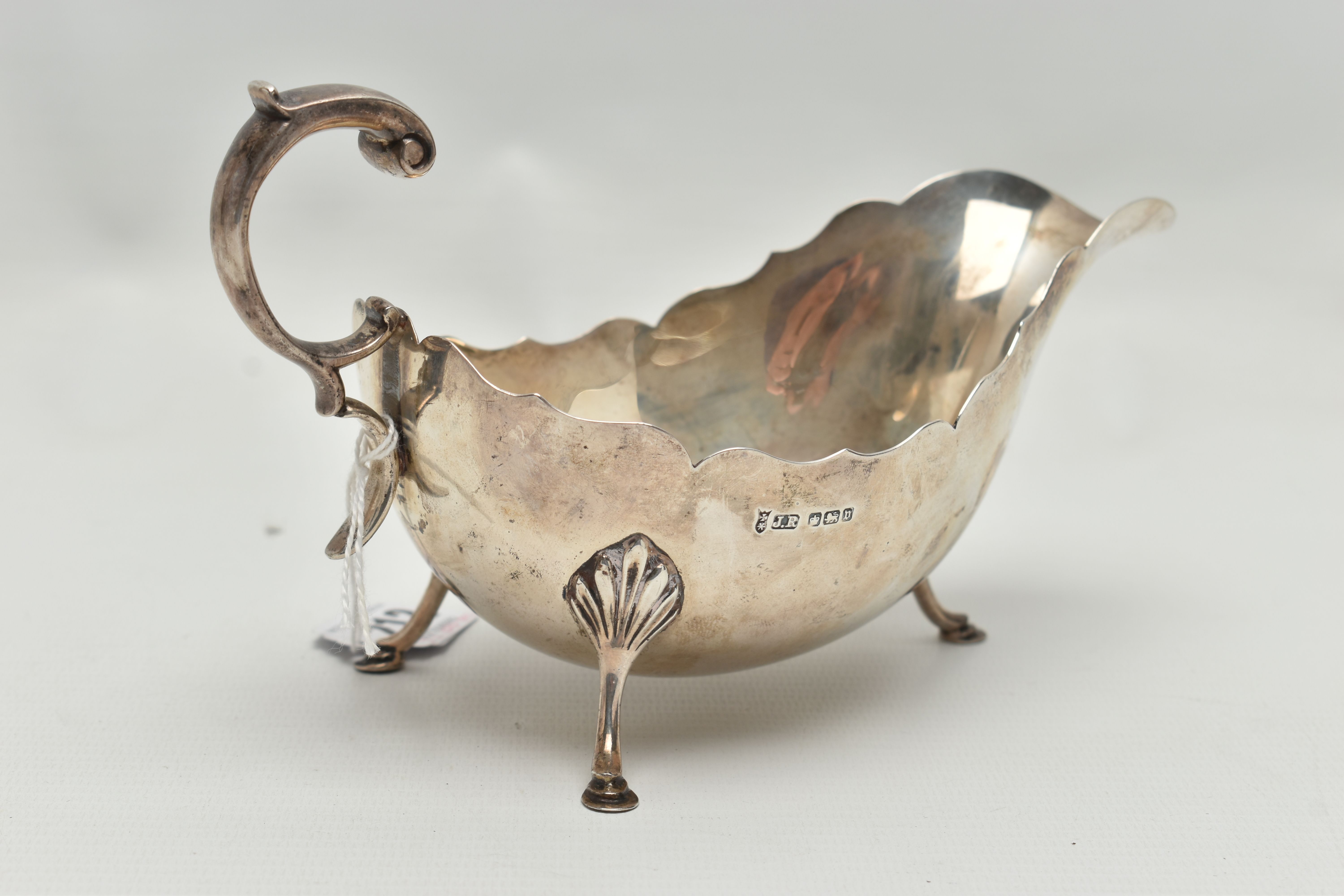 A GEORGE V SILVER SAUCE BOAT WITH WAVY RIM, 'S' scroll handle, on three cabriole legs with shell - Image 3 of 6