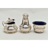 A GEORGE V SILVER THREE PIECE CONDIMENT SET OF CIRCULAR FORM, the mustard and salt with blue glass