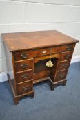 A REPRODUCTION GEORGIAN STYLE BURR WALNUT AND CROSSBANDED KNEE HOLE DESK, with seven drawers, on