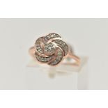 A 9CT ROSE GOLD DIAMOND FLOWER RING, flower set with single cut diamonds, to a polished band,