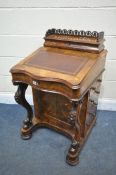 A VICTORIAN BURR WALNUT SERPENTINE DAVENPORT, the top with an open fretwork gallery, over a lid