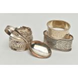 THREE 20TH CENTURY SILVER NAPKIN RINGS AND A SILVER BABY’S SPOON, including an oval napkin ring with
