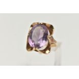 A 9CT GOLD AMETHYST RING, designed with a double four claw set, oval cut amethyst, measuring