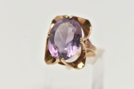 A 9CT GOLD AMETHYST RING, designed with a double four claw set, oval cut amethyst, measuring