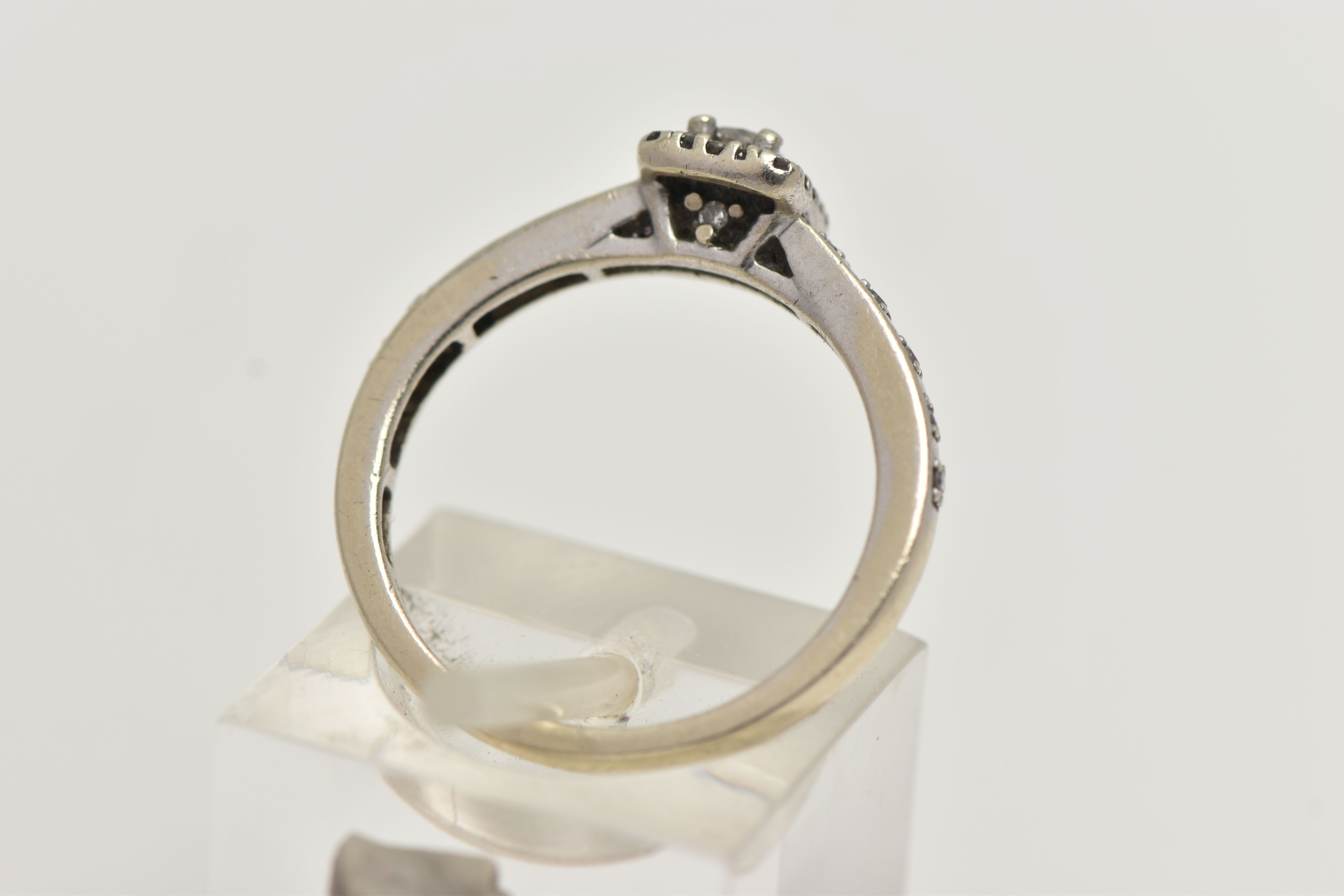 A 9CT WHITE GOLD DIAMOND CLUSTER RING, square head set with an emerald cut diamond, in a surround of - Image 3 of 4