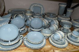 A NINETY SEVEN PIECE WEDGWOOD EMBOSSED QUEENS WARE DINNER SERVICE AND GIFTWARES, having white on