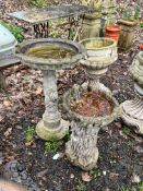 A COMPOSITE BIRD BATH, on a separate base with a floral design, 40cm diameter x height 65cm