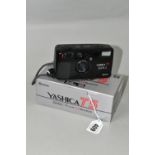 A BOXED YASHICA T5 COMPACT CAMERA WITH CARL ZEISS LENS, the black 35mm camera having a Carl Zeiss