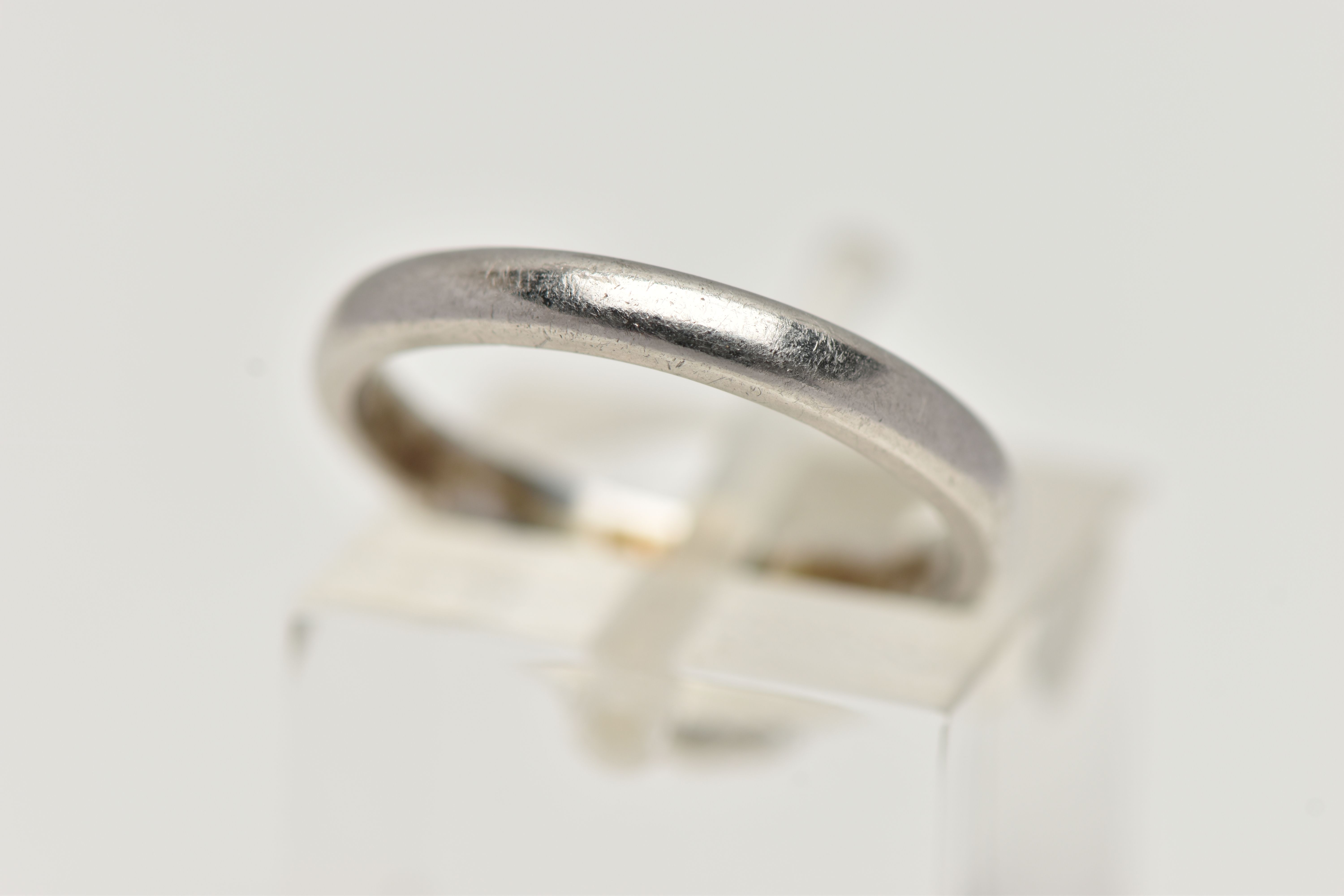 A POLISHED WHITE METAL BAND RING, unmarked band, ring size K, approximate gross weight 3.9 grams (