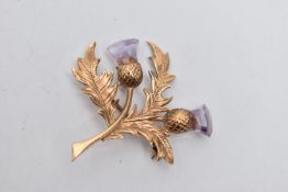 A 9CT GOLD THISTLE BROOCH, textured thistle brooch set with two faceted amethysts, fitted with a