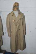 A LADIES' BURBERRY TRENCH COAT, approximate size UK 14/16, together with a cotton Burberry bucket