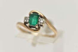 A 9CT GOLD EMERALD AND DIAMOND RING, designed with a rectangular cut emerald in a four claw setting,