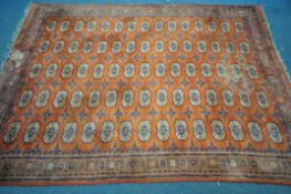 A 20TH CENTURY WOOLLEN TEKKE RUG, with a repeating pattern, 265cm x 191cm (condition:-low pile in