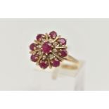 A 9CT GOLD RUBY AND DIAMOND CLUSTER RING, of a circular form, set with a central oval cut ruby in an