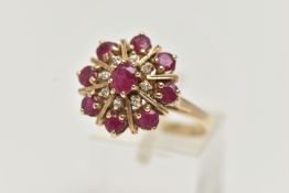 A 9CT GOLD RUBY AND DIAMOND CLUSTER RING, of a circular form, set with a central oval cut ruby in an