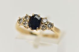AN 18CT GOLD SAPPHIRE AND DIAMOND RING, designed with a four claw set, oval cut deep blue