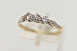 AN EARLY 20TH CENTURY THREE STONE DIAMOND RING, claw set with a central old cut diamond, flanked