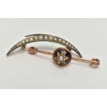 TWO BROOCHES, the first a polished rose metal bar, fitted with a domed garnet with star detail set