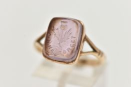 A YELLOW METAL INTAGLIO RING, purple paste intaglio of a rectangular form, engraved with a thistle
