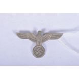 A THIRD REICH, NAZI GERMANY EAGLE HAT/UNIFORM BADGE, it's made from a white metal and features an