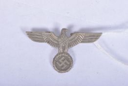A THIRD REICH, NAZI GERMANY EAGLE HAT/UNIFORM BADGE, it's made from a white metal and features an