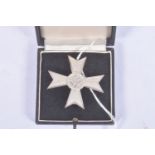 A GERMAN THIRD REICH FIRST CLASS WAR MERIT CROSS WITHOUT SWORDS, this merit cross is silver in