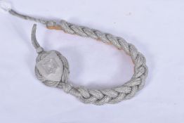 A GERMAN NAZI THIRD REICH SHOOTING LANYARD, this has interwoven silver thread and features a metal