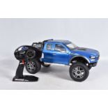 A TRAXXAS REMOTE CONTROLLED FORD PICKUP TRUCK, heavy built frame, blue painted body with black and