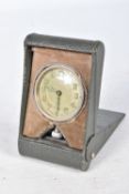 A CASED FOLDING TRAVEL CLOCK, silvered dial with luminescent Arabic numerals with the full 24 hour