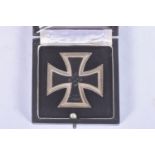 A CASED WWII IRON CROSS FIRST CLASS, THE CROSS ITSELF SHOWS SOME WEAR to the front and back and