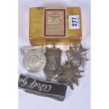 A TIN CONTAINING TWO GERMAN WAR MERIT CROSSES WITH SWORDS, A BELT BUCKLE, 1929 NURNBERG SHEILD and a