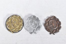 THREE GERMAN DRIVER CERTIFICATION BADGES, OR DRIVER PROFICIENCY BADGES, these were worn on the lower