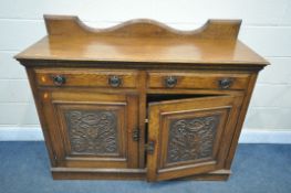 AN ARTS AND CRAFTS OAK SIDEBOARD, with a shaped raised back, two frieze drawers with circular